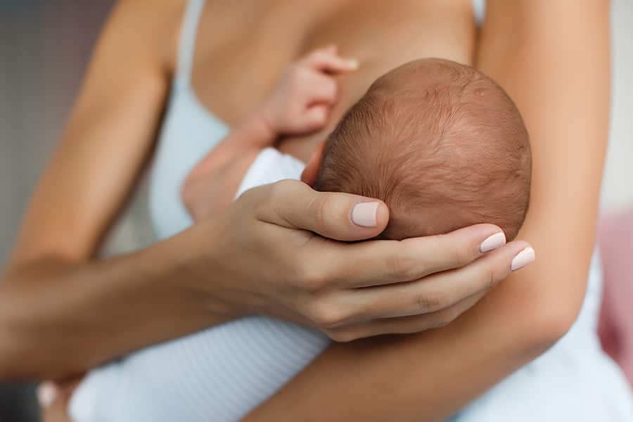 A mother breastfeeding a baby